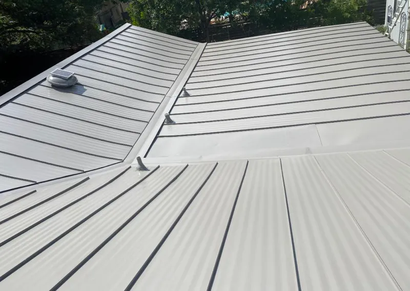 Solar attic fan installed on a metal roof for Roof Ventilation in Bothell West